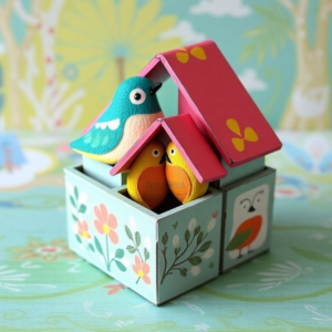 vibrant paint colors and stencils, artistic designs on paper mache nesting boxes, creative DIY home decor project